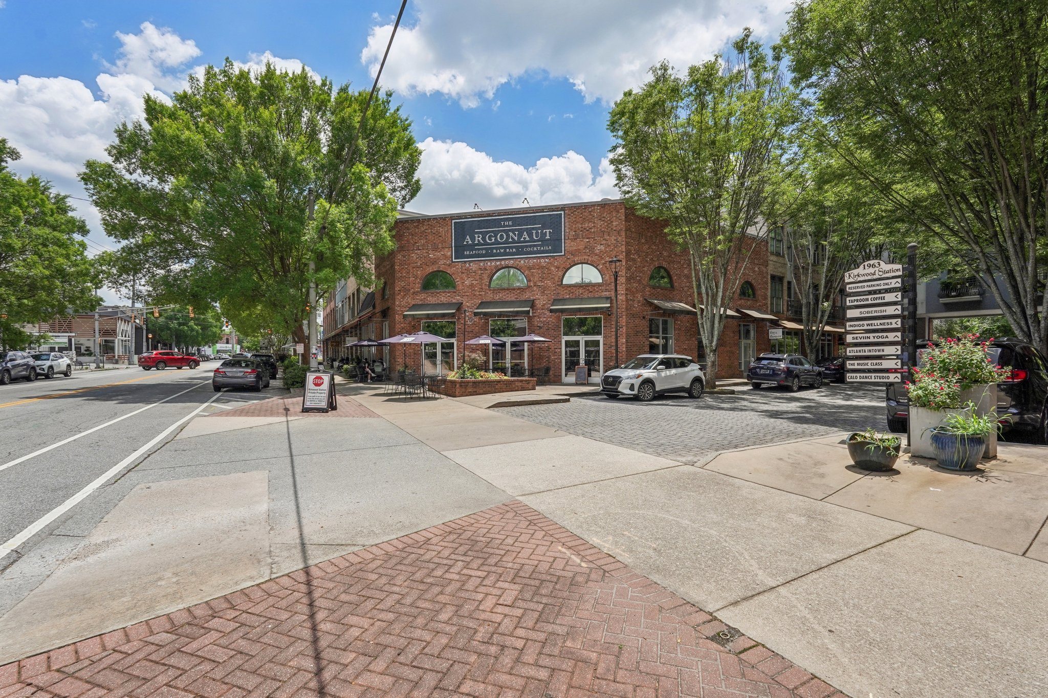 A street view with restaurant Argonaut in front view, with many other shops cafes, and wellness spots in town.